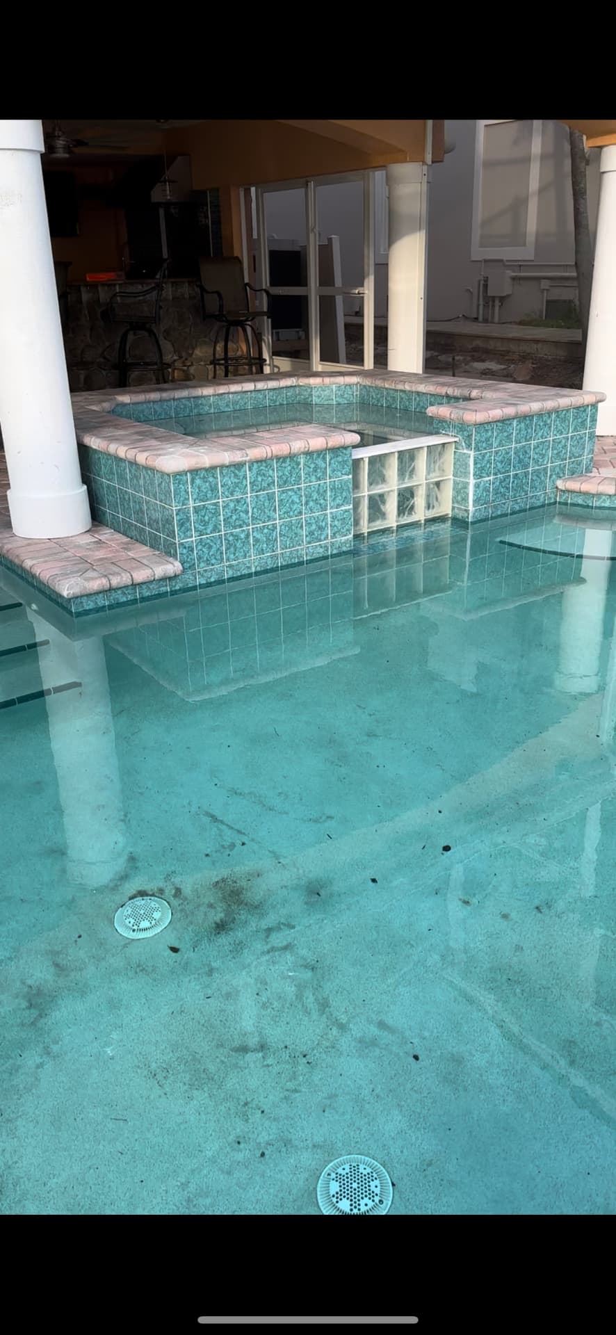 Stained, discolored pool and spa interior with heavy buildup before restoration