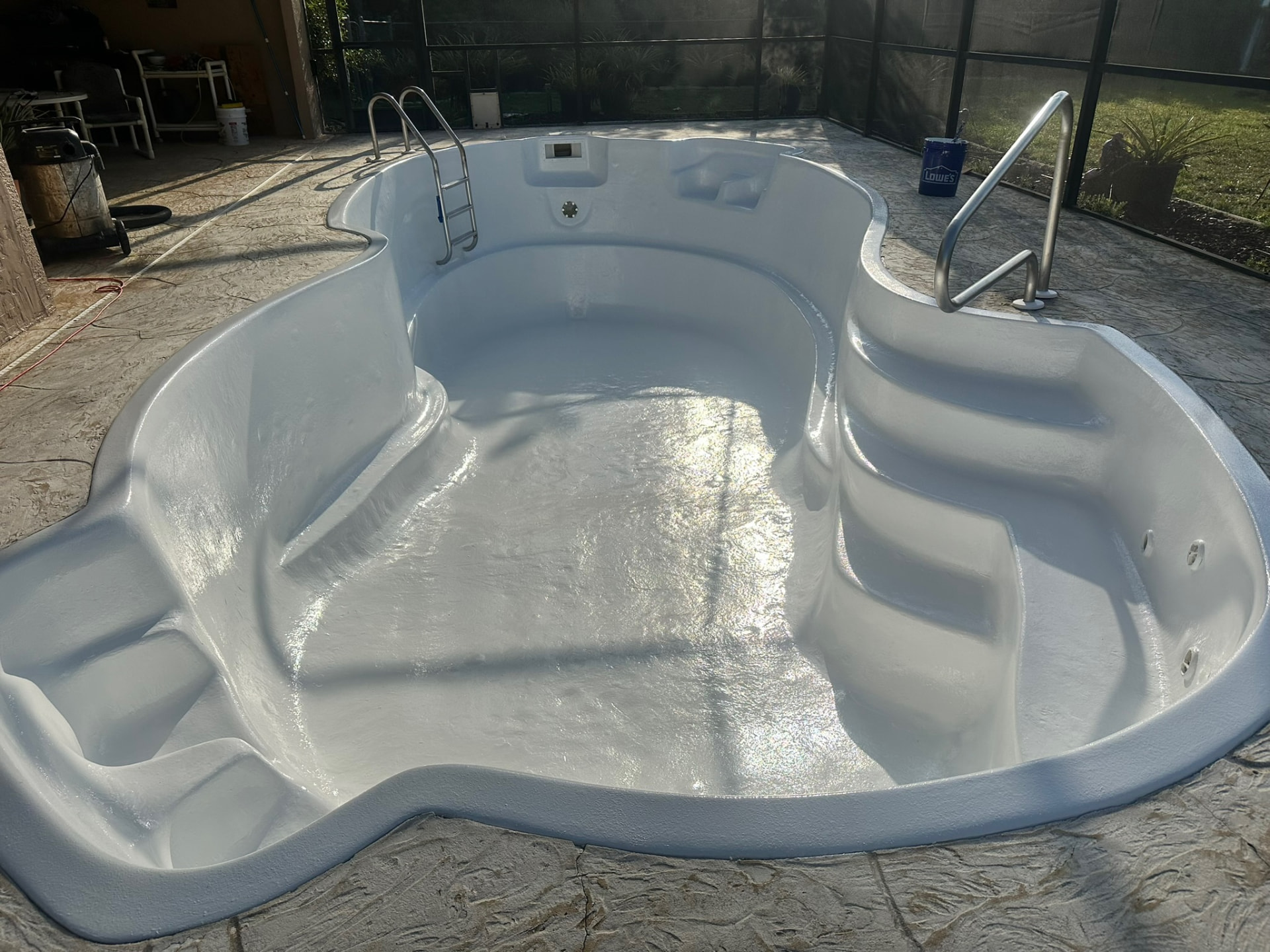 Fiberglass pool shell after prep with a fresh, uniform new coating applied